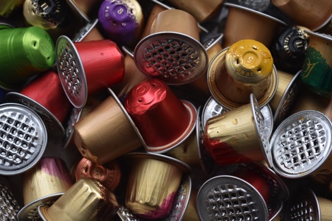 A pile of multi-coloured aluinium coffee pods